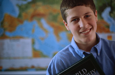 Adolescent Boy Holding a Textbook ca. 2000